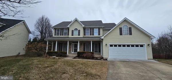 a view of a house with a yard and garage
