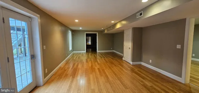 a view of hallway with wooden floor