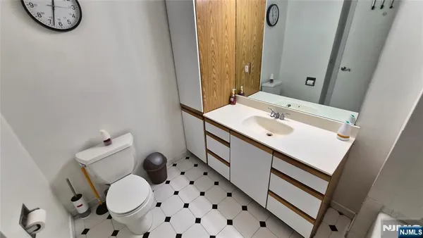 a bathroom with a sink mirror vanity and toilet