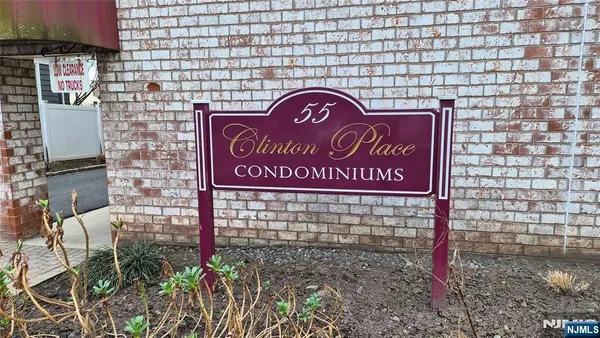 a sign on the brick wall
