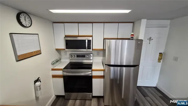 a kitchen with a refrigerator a stove and a sink