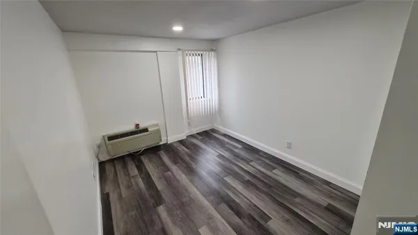 a view of room with wooden floor