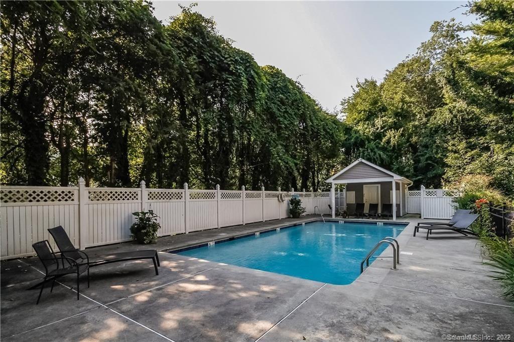 a view of a house with a patio and a yard