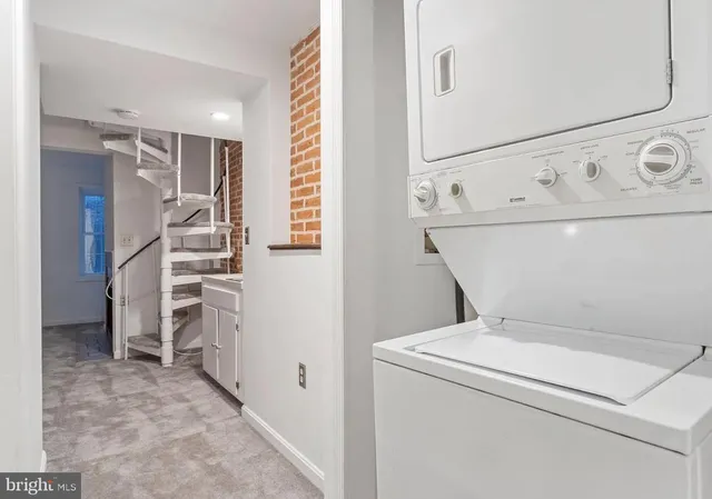 a view of washer and dryer with kitchen in the background