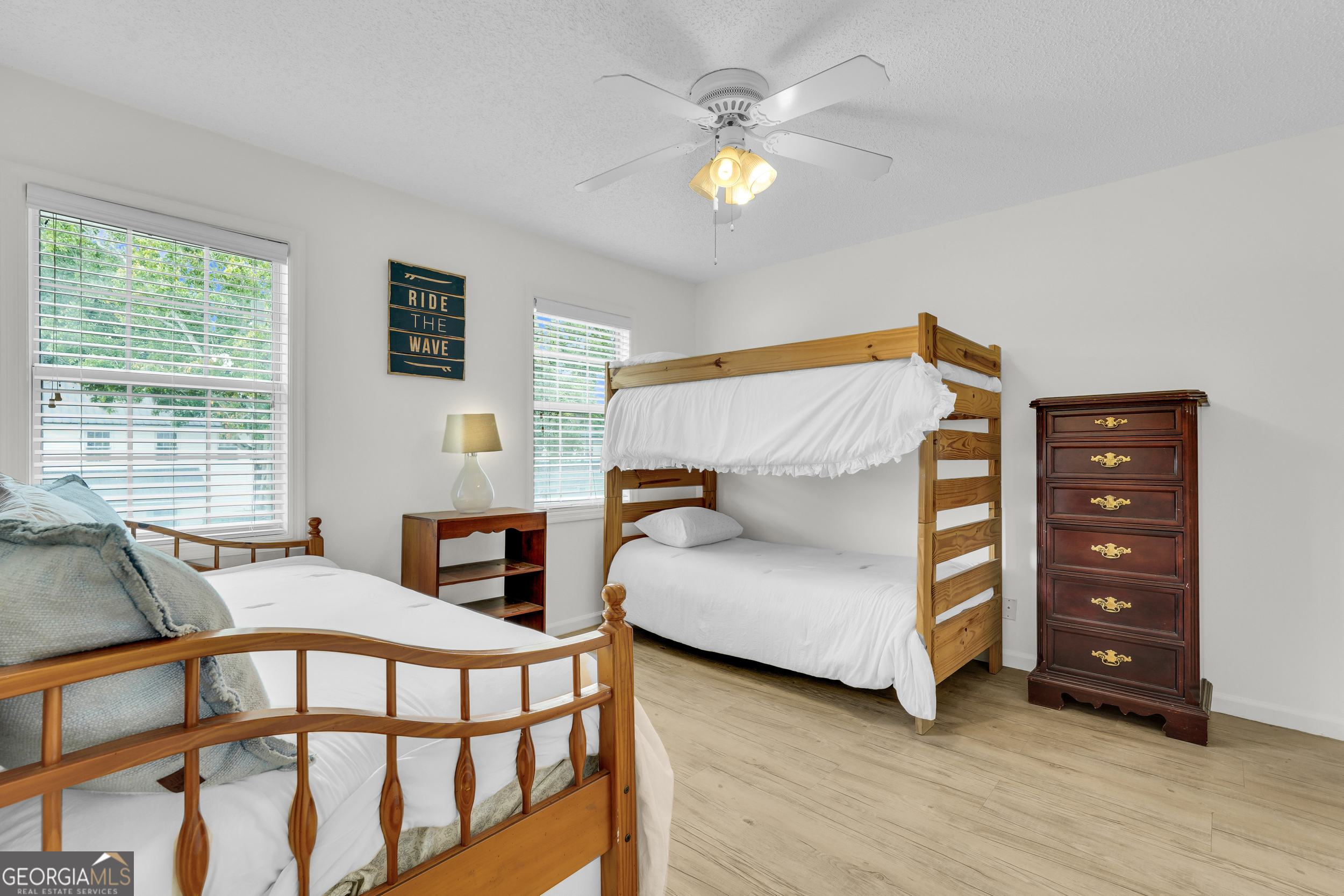114 South Island Square Drive St. Simons, GA 31522 - Photo 32 of 51 a bedroom with a bed and a chandelier