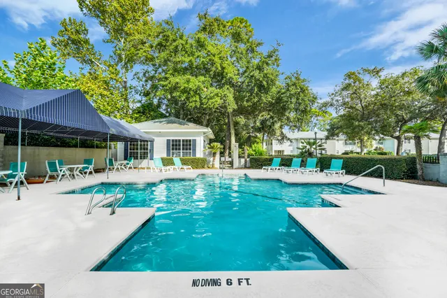 a view of a house with backyard sitting area and garden