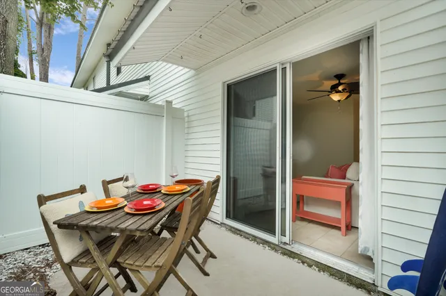 a backyard of a house with table and chairs
