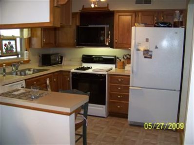 8806 Liable Road Highland, IN 46322 - Photo 3 of 10 a kitchen with a refrigerator and a stove top oven