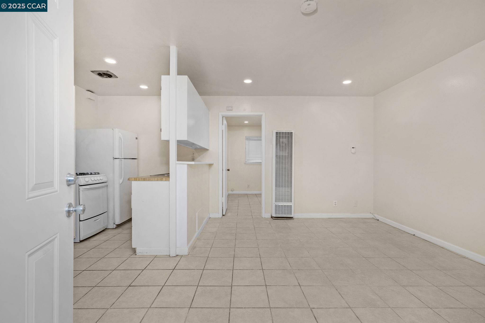 1926 Alcatraz Avenue, Unit 2 Berkeley, CA 94703 - Photo 5 of 13 a view of a refrigerator in kitchen and white cabinets