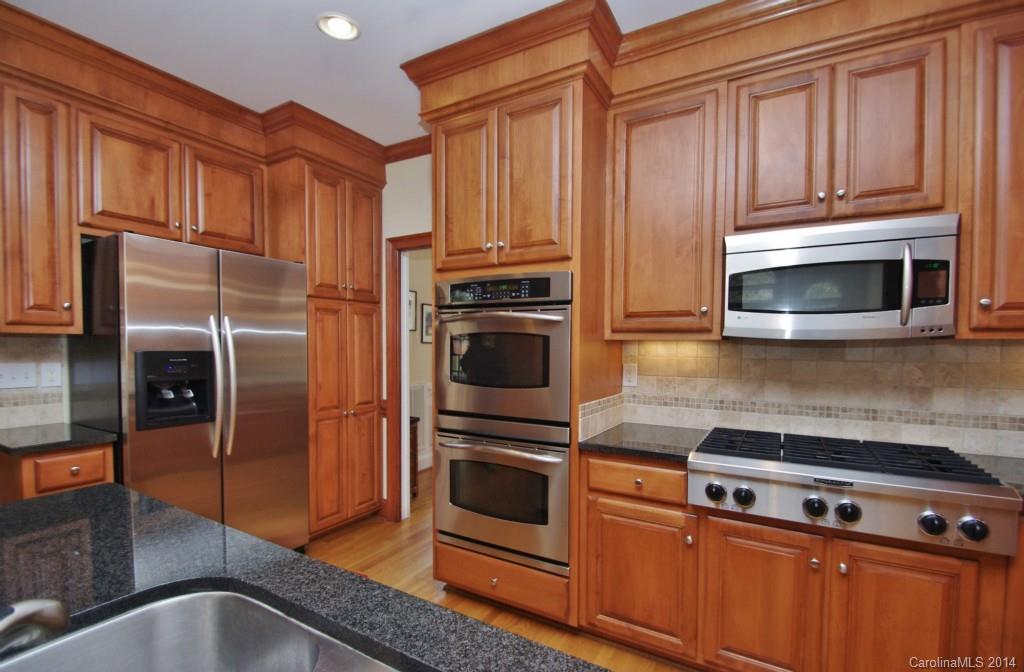 1640 Windy Ridge Road Charlotte, NC 28270 - Photo 11 of 22 a kitchen with granite countertop a refrigerator stove and microwave