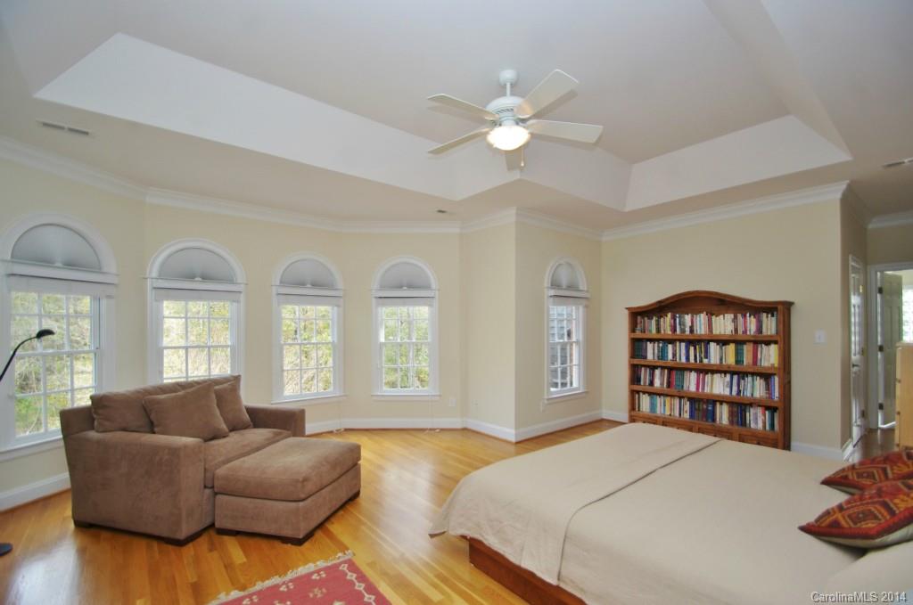 1640 Windy Ridge Road Charlotte, NC 28270 - Photo 14 of 22 a spacious bedroom with a bed a couch and a large window