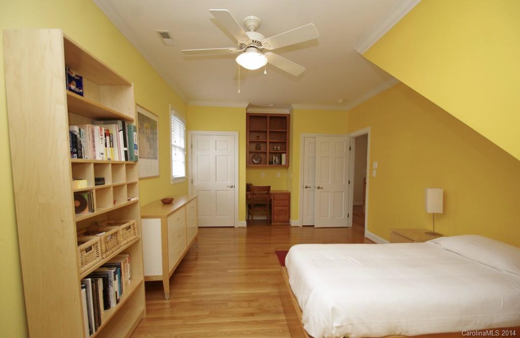 1640 Windy Ridge Road Charlotte, NC 28270 - Photo 17 of 22 a bedroom with a bed and a book shelf