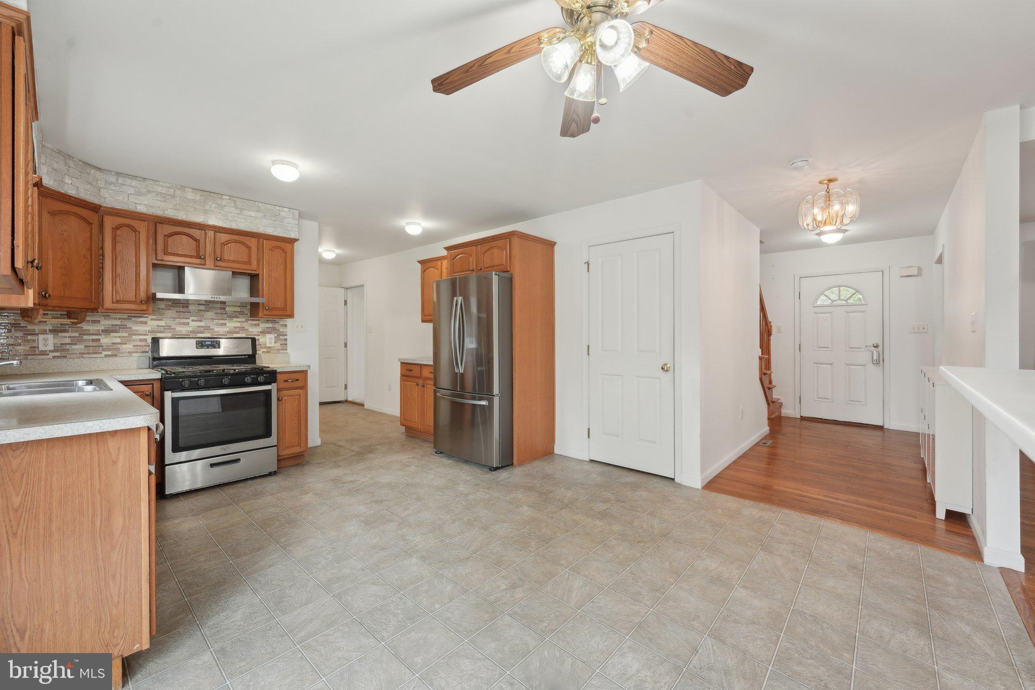 3026 Highley Road Eagleville, PA 19403 - Photo 11 of 46 a view of kitchen with stainless steel appliances kitchen island empty cabinets and wooden floor