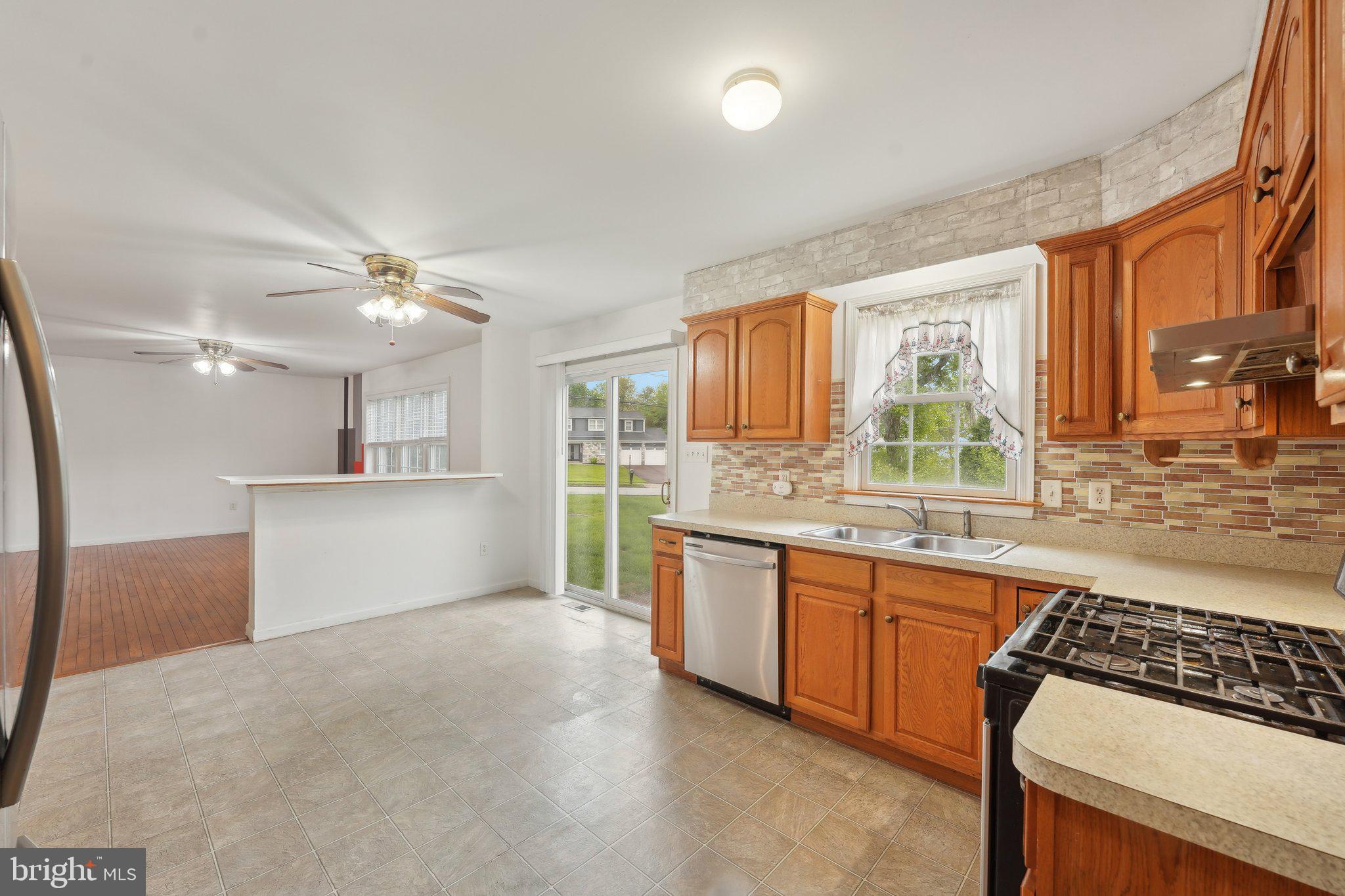 3026 Highley Road Eagleville, PA 19403 - Photo 14 of 46 a kitchen with stainless steel appliances granite countertop a sink stove and refrigerator