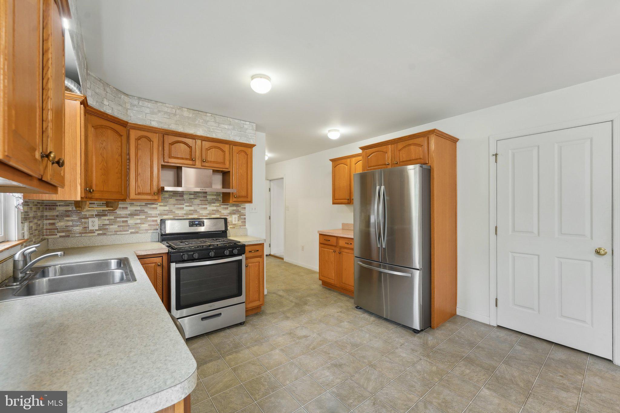 3026 Highley Road Eagleville, PA 19403 - Photo 16 of 46 a kitchen with stainless steel appliances granite countertop a refrigerator stove and sink