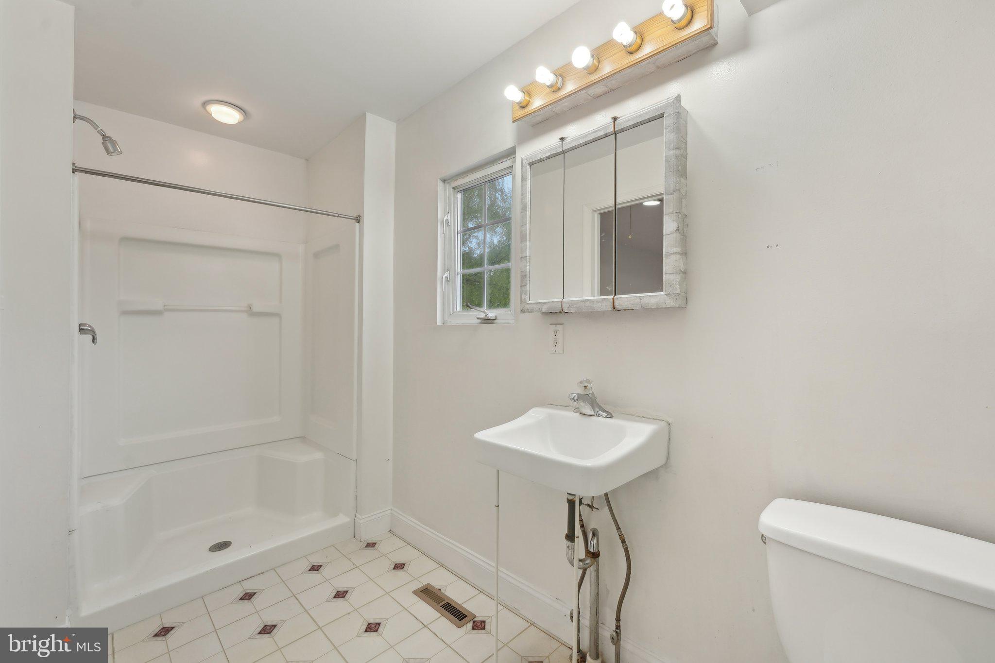 3026 Highley Road Eagleville, PA 19403 - Photo 23 of 46 a bathroom with a sink a toilet and shower