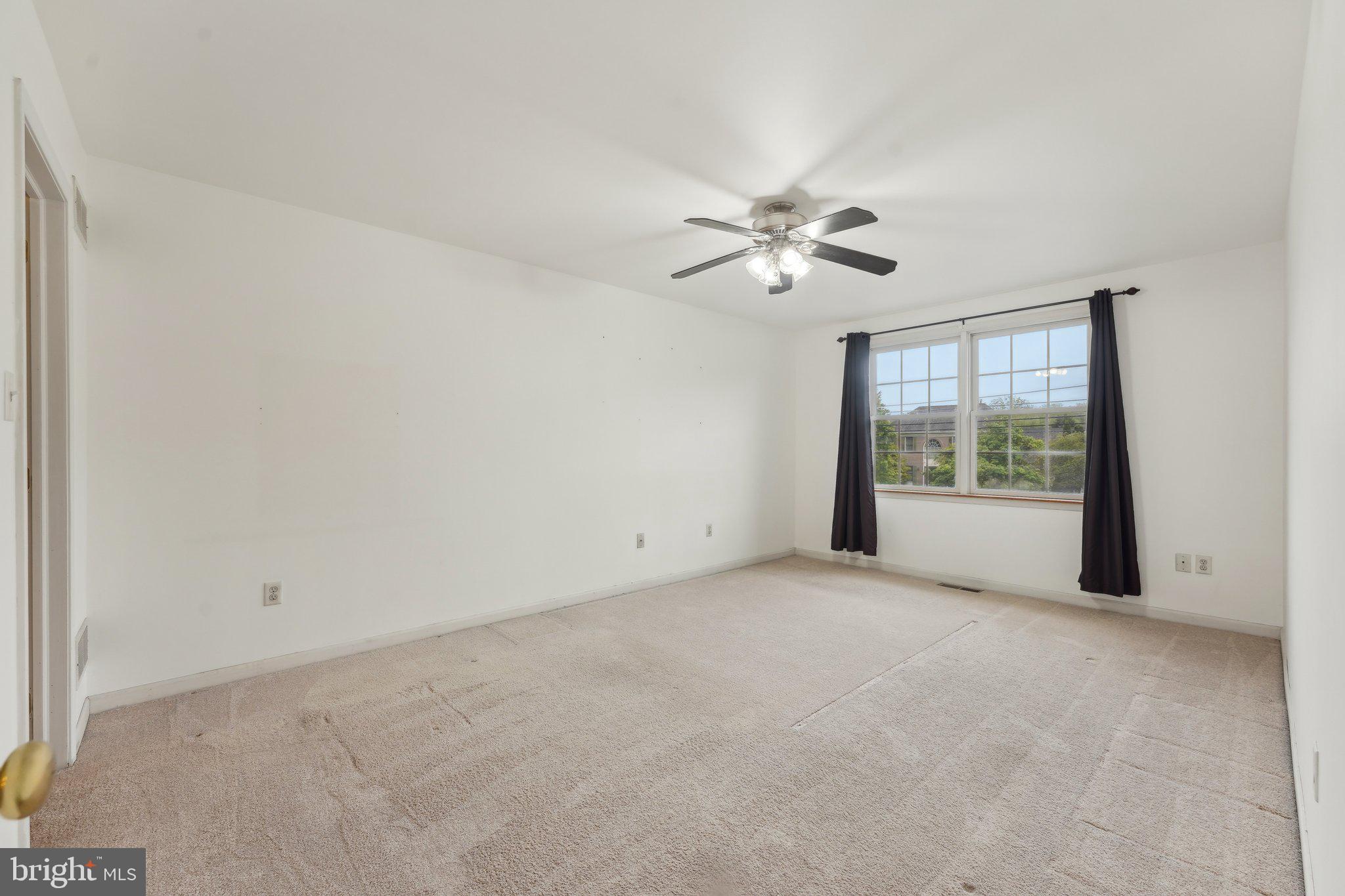 3026 Highley Road Eagleville, PA 19403 - Photo 24 of 46 an empty room with chandelier fan and windows