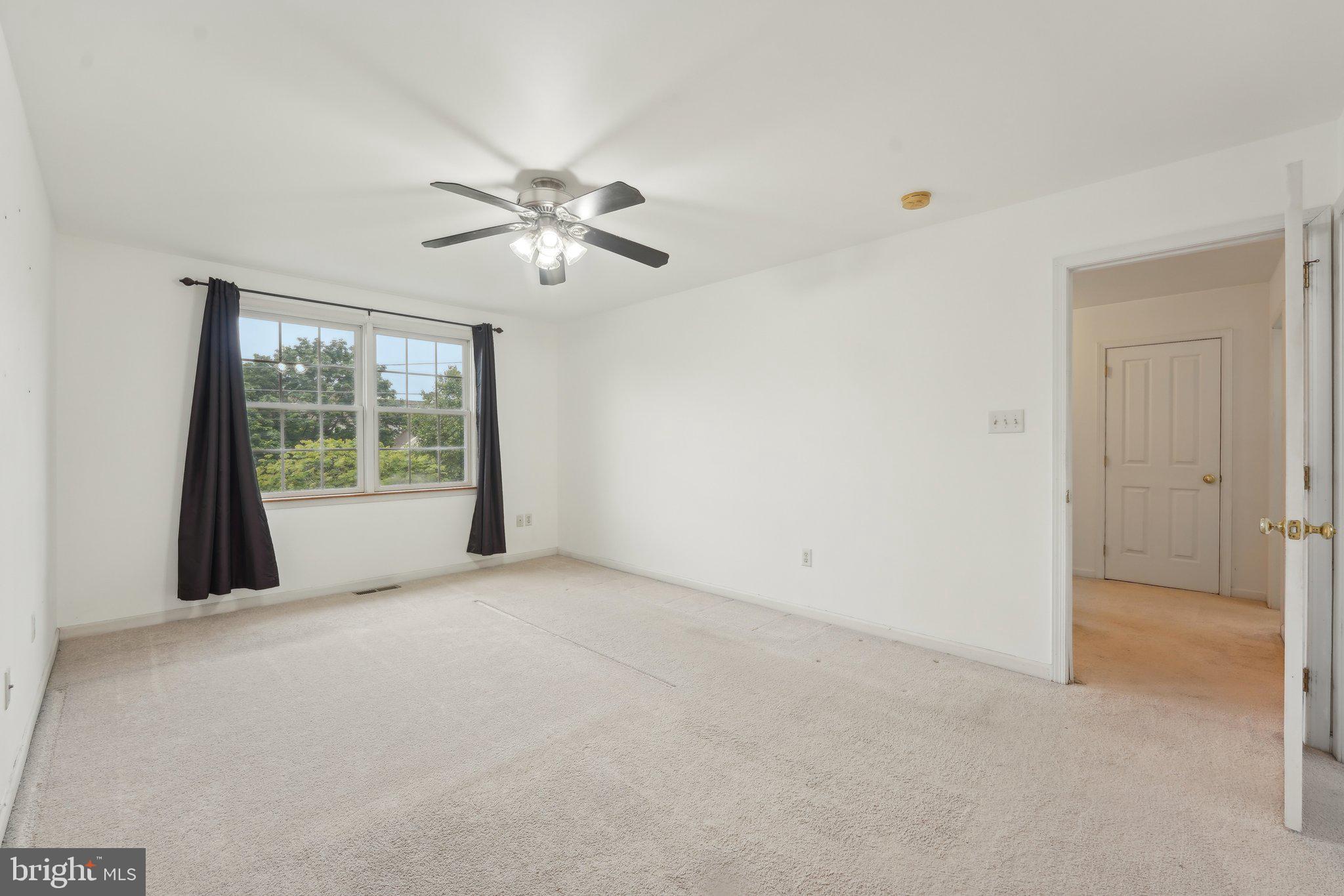 3026 Highley Road Eagleville, PA 19403 - Photo 25 of 46 a view of a big room with windows and chandelier fan