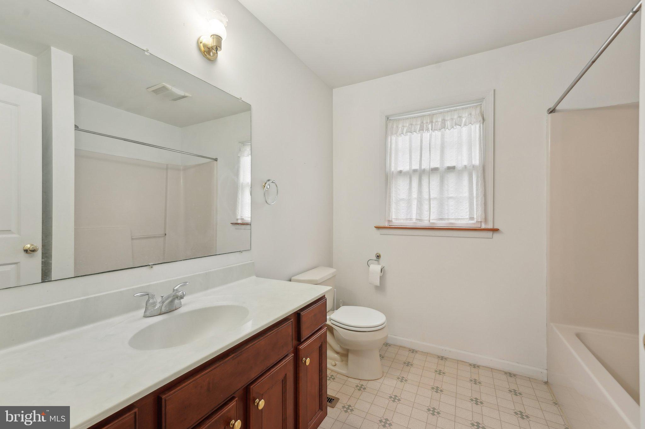 3026 Highley Road Eagleville, PA 19403 - Photo 27 of 46 a bathroom with a toilet sink and mirror
