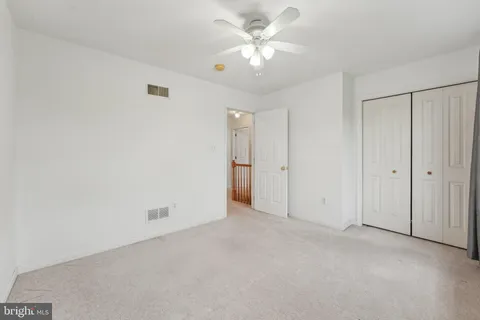 an empty room with fan and a ceiling fan