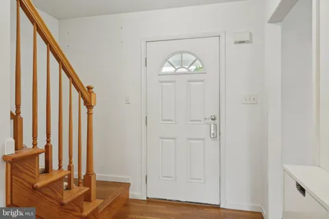 a view of an entryway with wooden floor