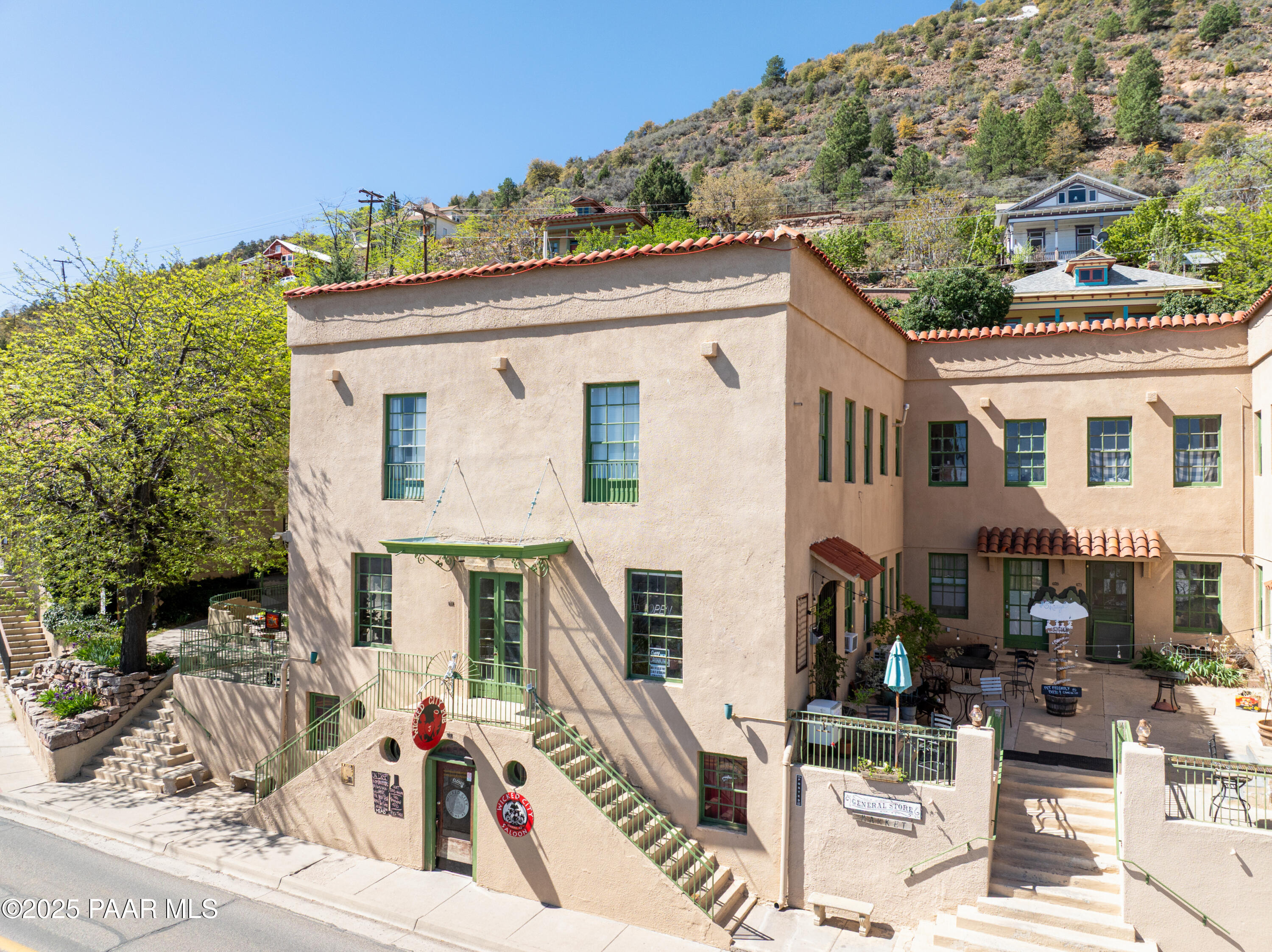403 Clark Street Jerome, AZ 86331 - Photo 9 of 60 a view of a white house with large windows and couches chairs