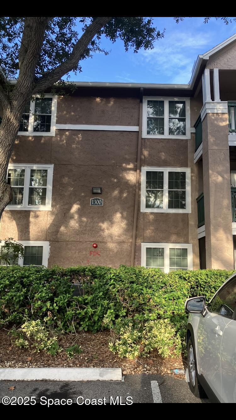 7667 North Wickham Road, Unit 1318 Melbourne, FL 32940 - Photo 1 of 18 a view of a house with a garden