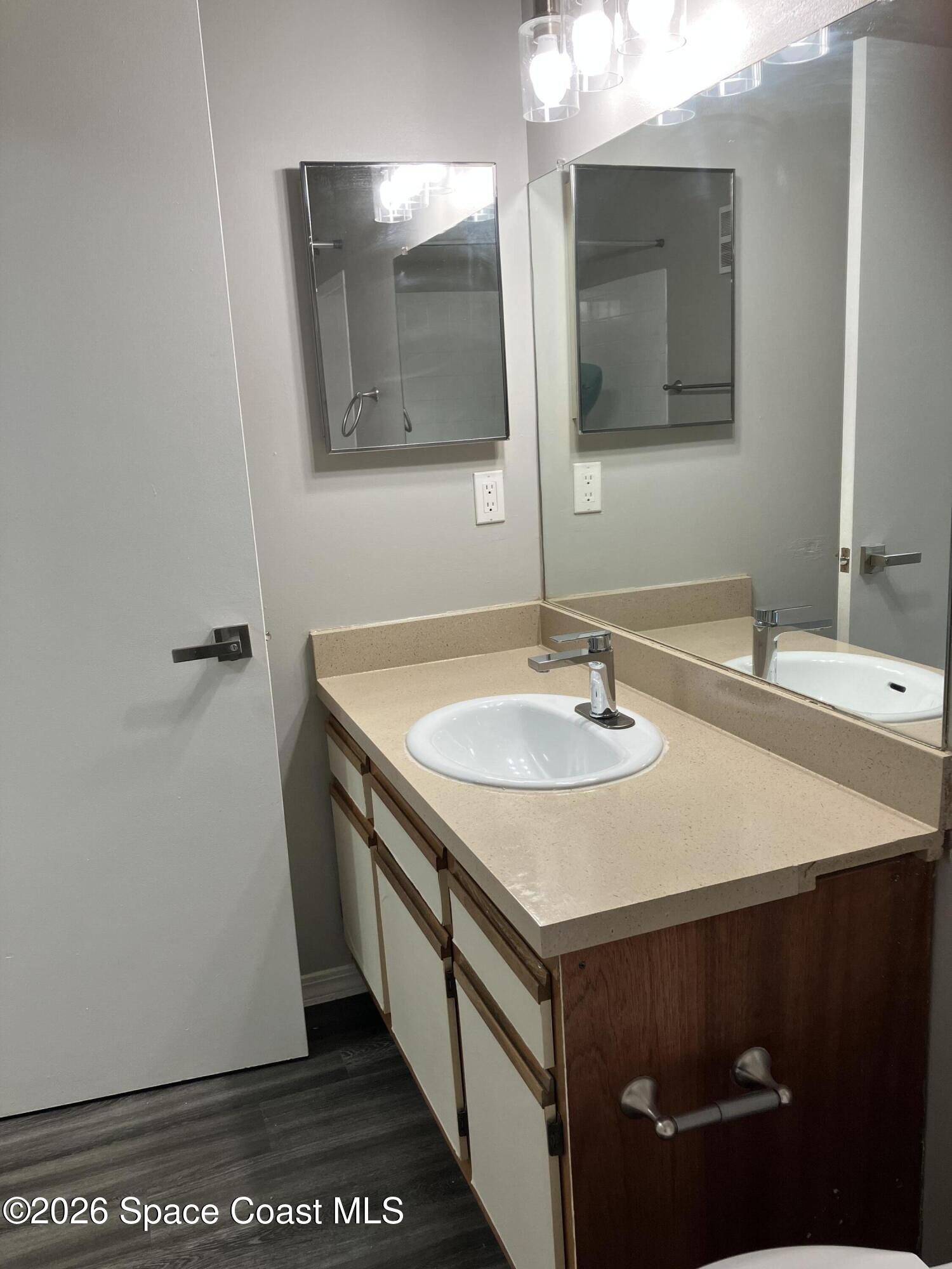7667 North Wickham Road, Unit 1318 Melbourne, FL 32940 - Photo 11 of 18 a bathroom with a sink and a mirror