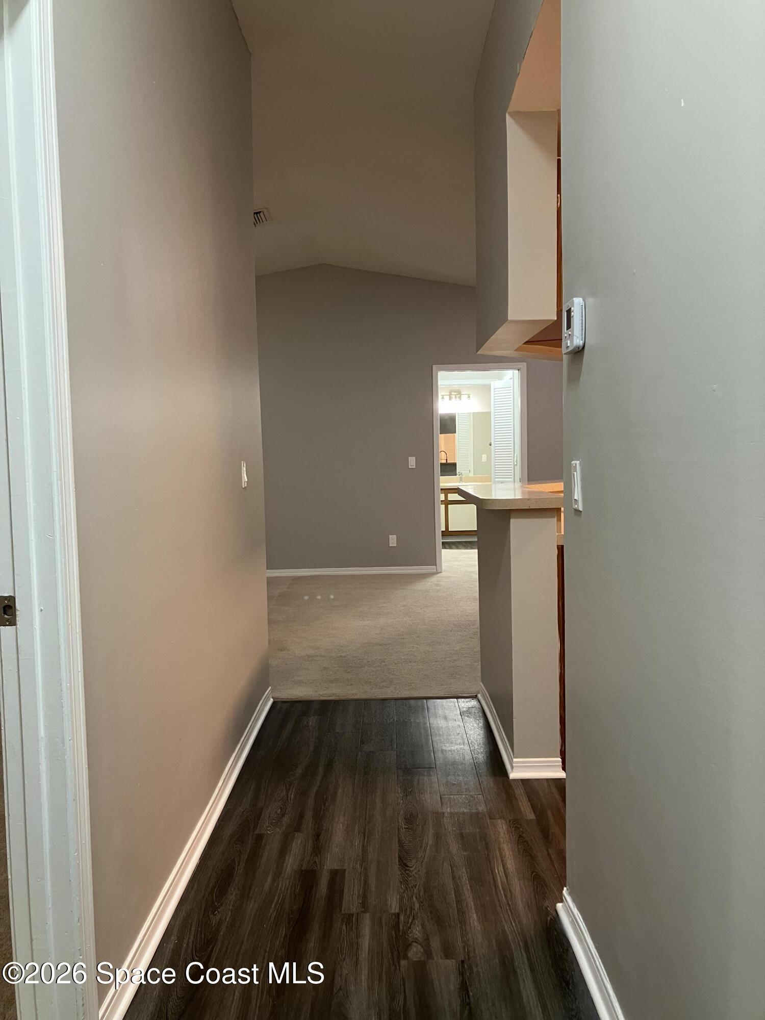 7667 North Wickham Road, Unit 1318 Melbourne, FL 32940 - Photo 3 of 18 a view of empty room with wooden floor