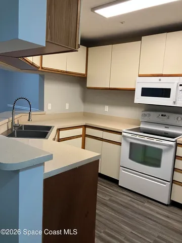 a kitchen with a sink cabinets and appliances