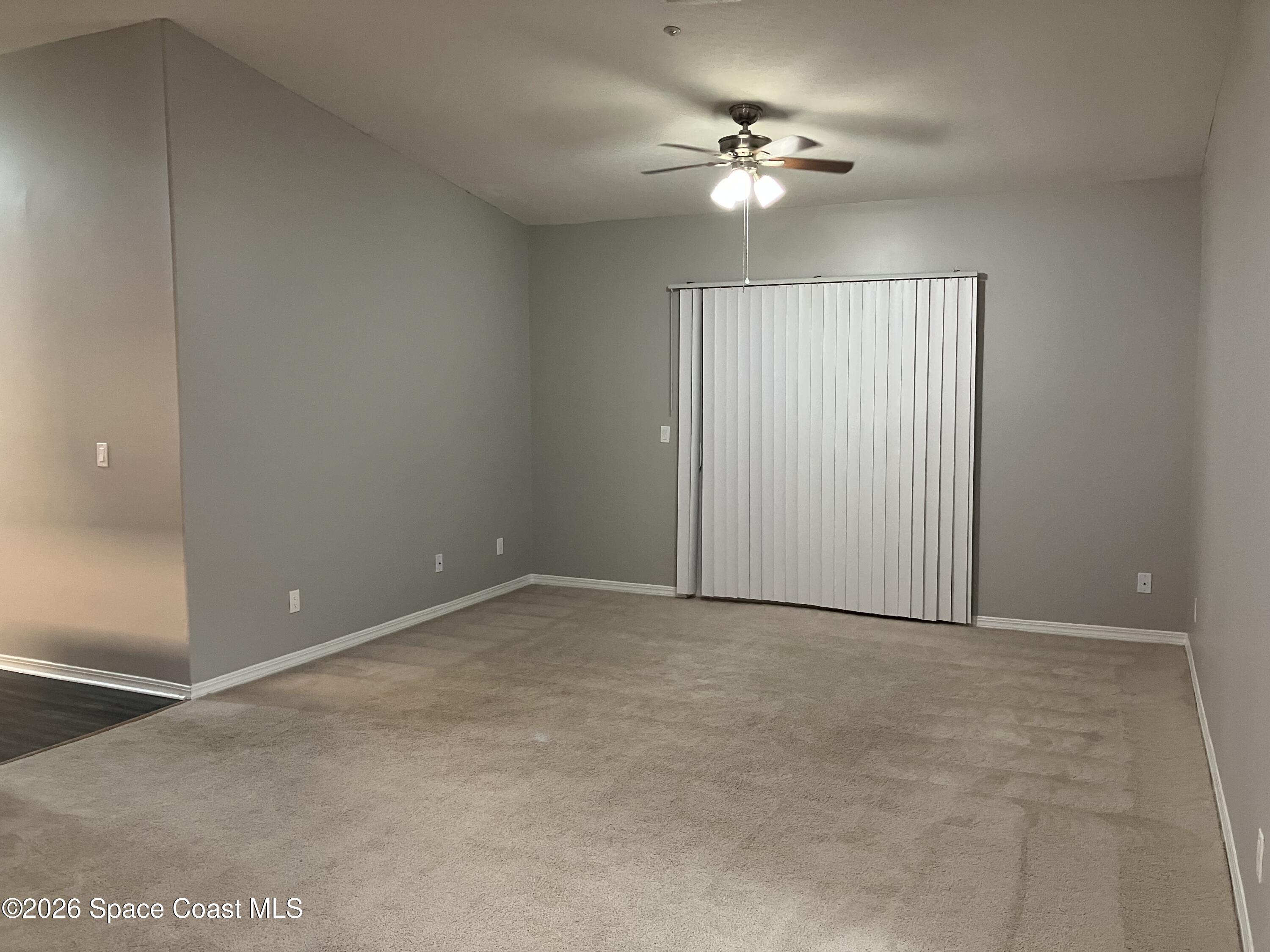 7667 North Wickham Road, Unit 1318 Melbourne, FL 32940 - Photo 7 of 18 an empty room with fan and windows