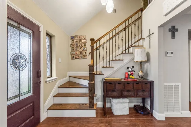 a view of entryway and hall with wooden floor