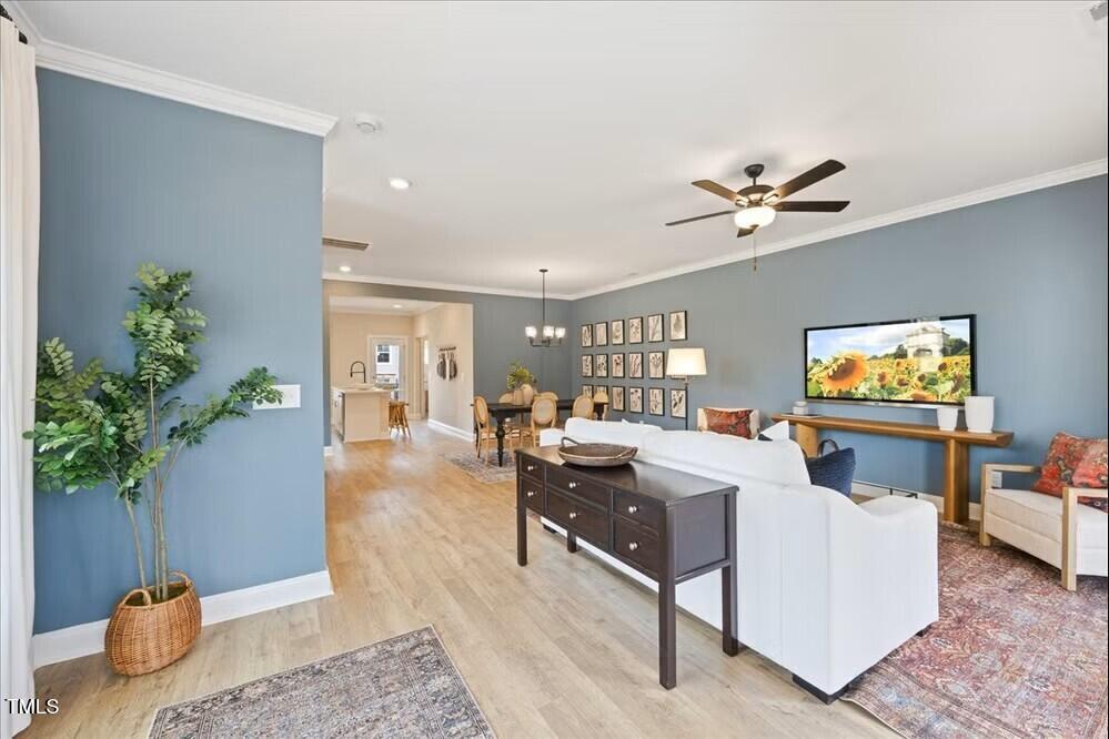 541 Forestville Road Wake Forest, NC 27587 - Photo 10 of 47 a living room with furniture and a potted plant