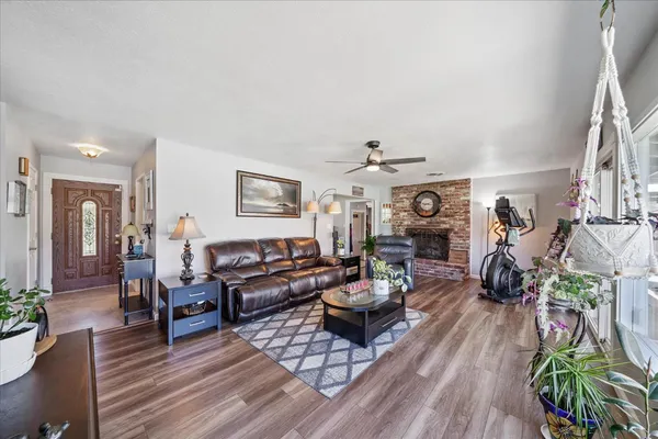 a living room with furniture and wooden floor