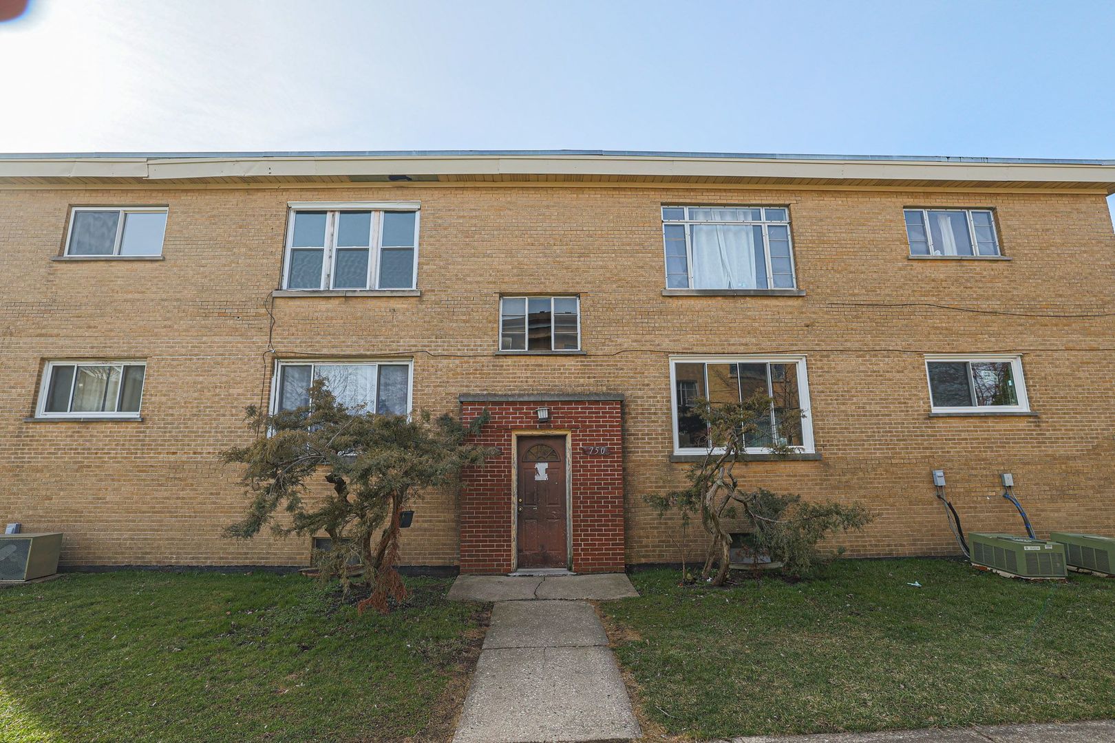 746 Walnut Street, Unit 2E Waukegan, IL 60085 - Photo 1 of 21 a front view of a house with a garden