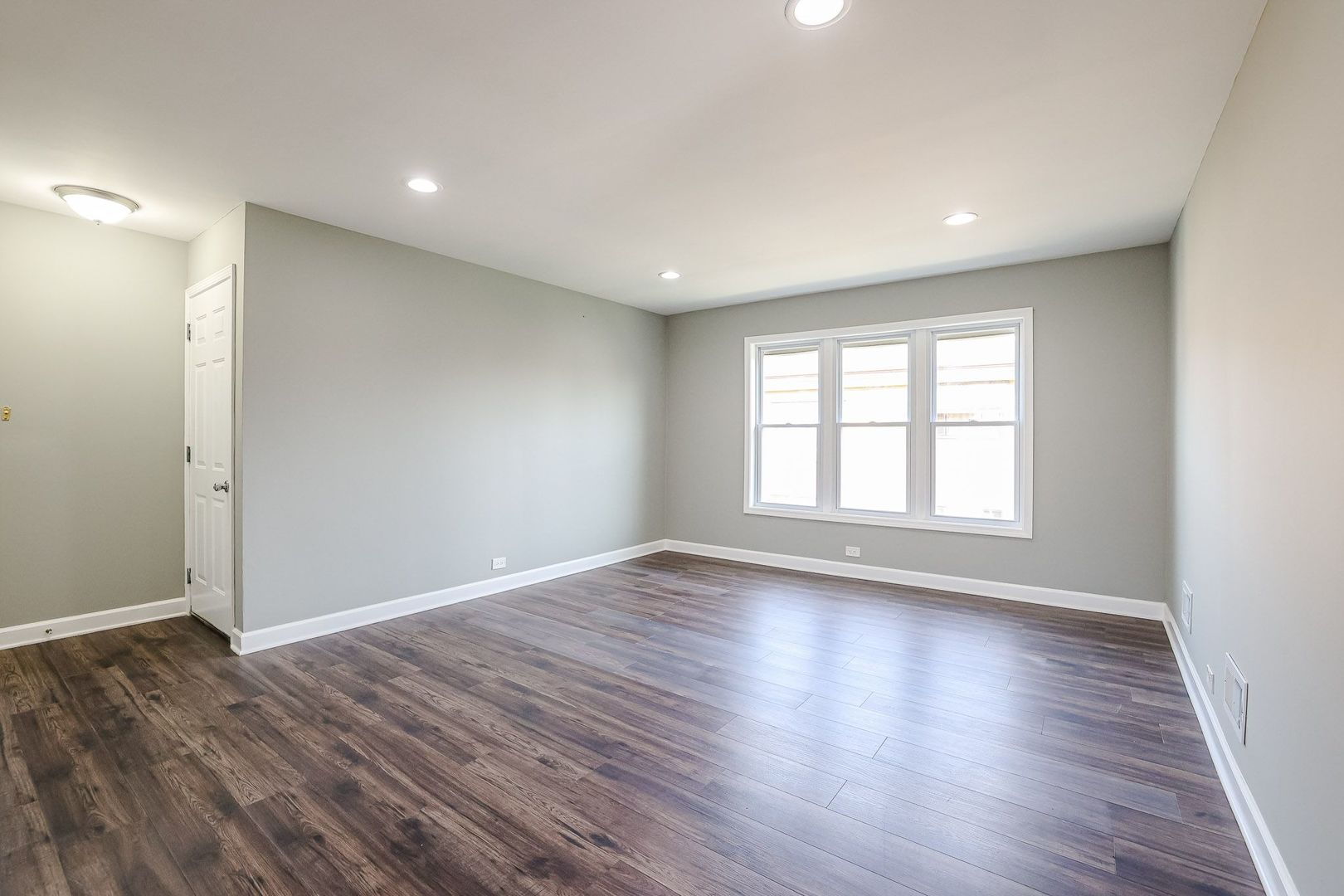746 Walnut Street, Unit 2E Waukegan, IL 60085 - Photo 5 of 21 a view of empty room with wooden floor and fan