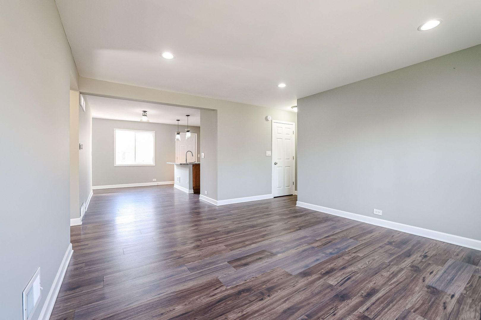 746 Walnut Street, Unit 2E Waukegan, IL 60085 - Photo 6 of 21 a view of wooden floor and windows in an empty room