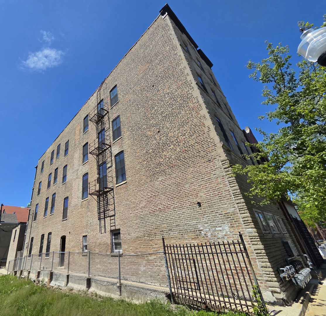 3216 South Morgan Street, Unit 3F Chicago, IL 60608 - Photo 6 of 6 a view of a building with a yard