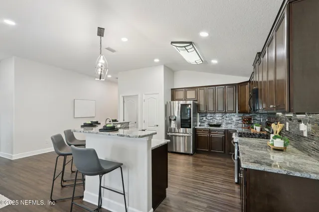 a kitchen with lots of counter top space and stainless steel appliances
