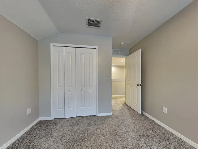 a view of an empty room and closet area