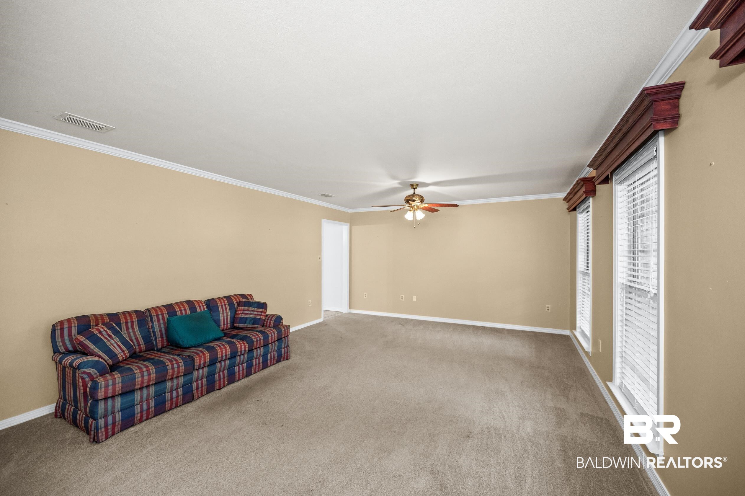 303 West Palm Avenue Foley, AL 36535 - Photo 14 of 32 Living room with ornamental molding, carpet, and ceiling fan