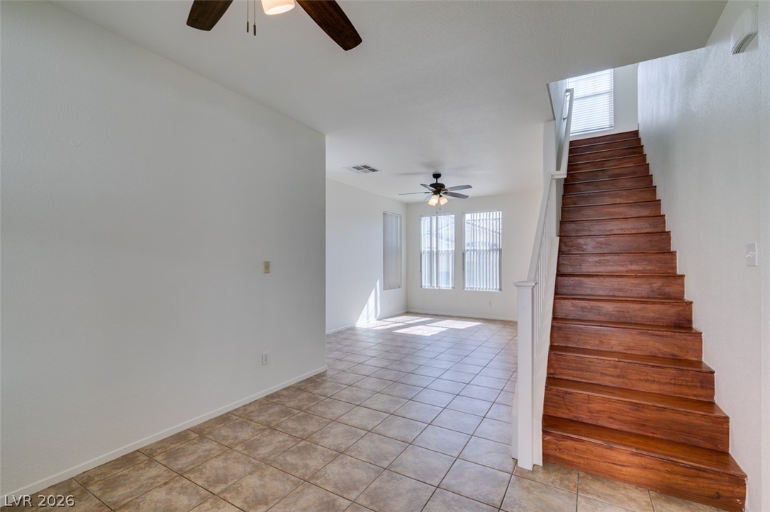 4957 Miners Ridge Drive Las Vegas, NV 89122 - Photo 17 of 39 This bright, open space features tile flooring and a grand wooden staircase.
