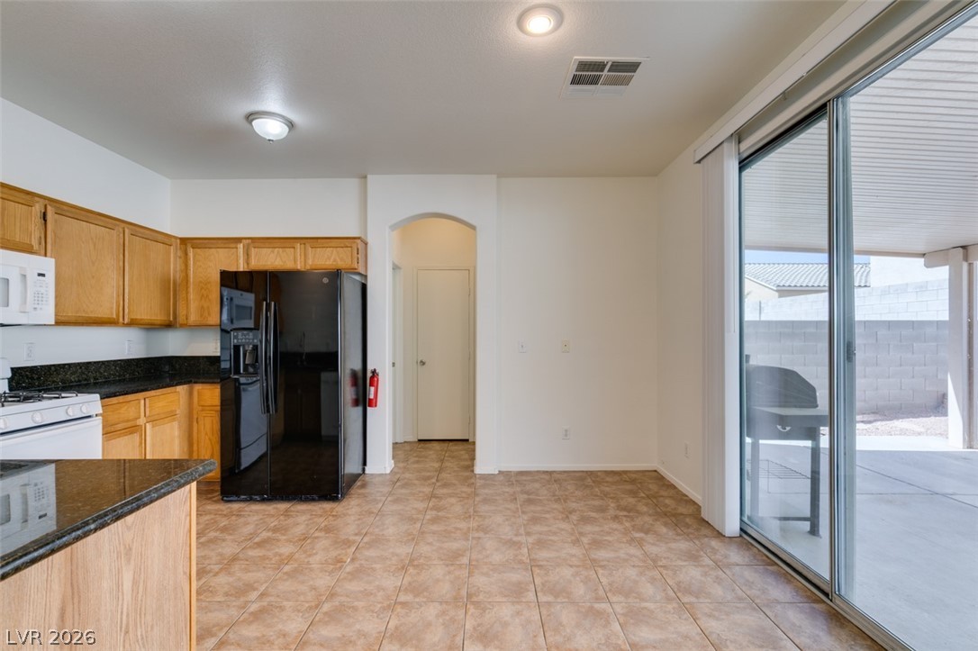4957 Miners Ridge Drive Las Vegas, NV 89122 - Photo 20 of 39 This spacious eat-in kitchen features granite counters, modern appliances, and convenient outdoor access.