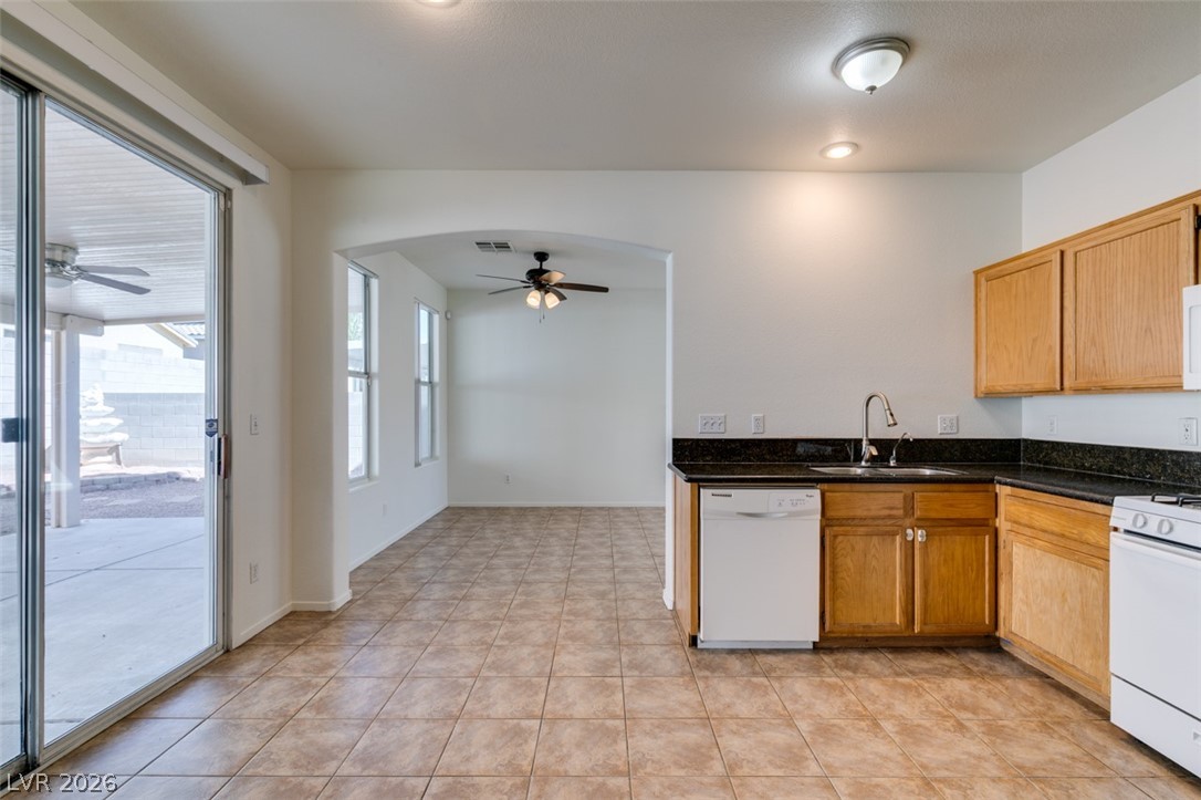 4957 Miners Ridge Drive Las Vegas, NV 89122 - Photo 24 of 39 Bright and inviting kitchen and living space, featuring practical amenities and direct patio access.