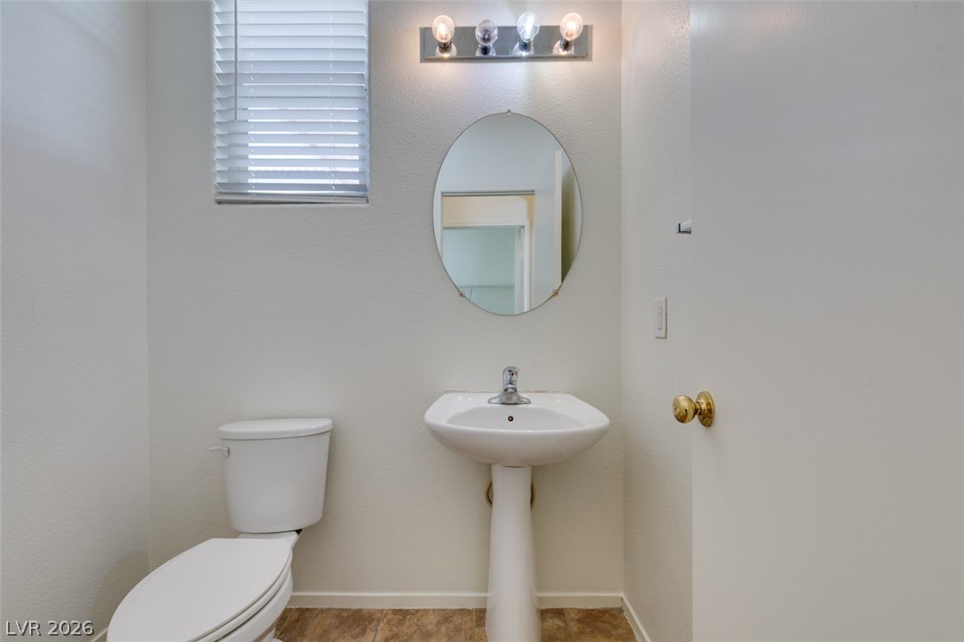 4957 Miners Ridge Drive Las Vegas, NV 89122 - Photo 25 of 39 This clean and functional powder room provides essential convenience for guests and residents alike.