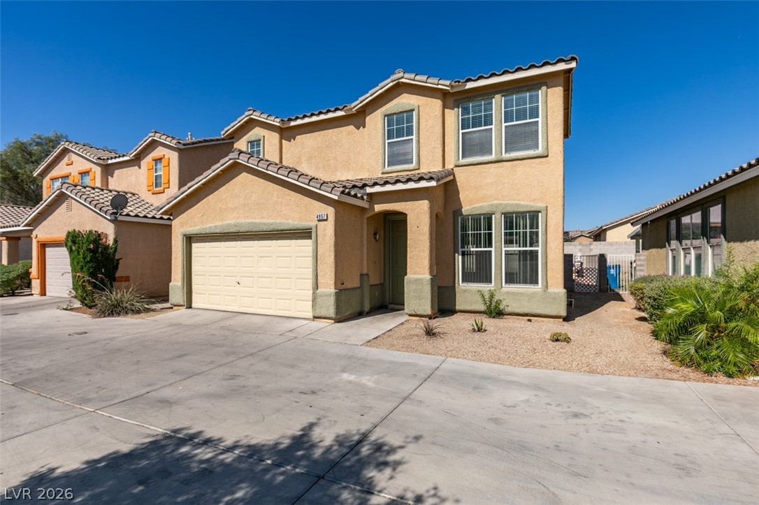 4957 Miners Ridge Drive Las Vegas, NV 89122 - Photo 3 of 39 This two-story residence boasts an attached garage and a neatly maintained front yard.