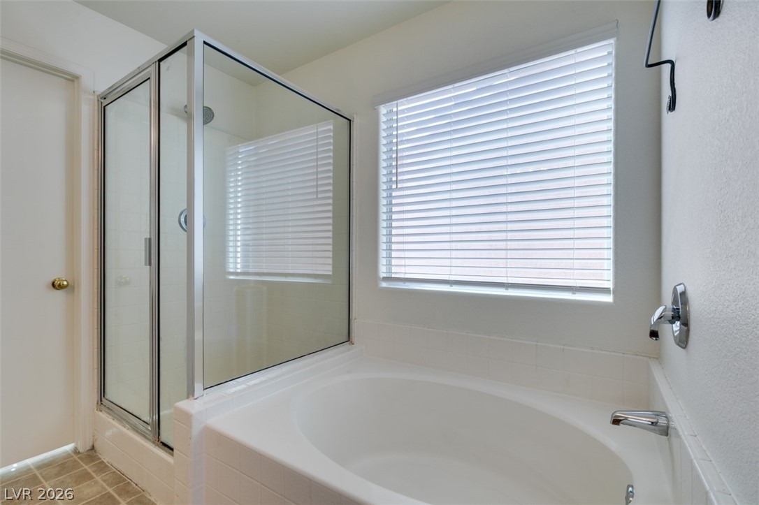 4957 Miners Ridge Drive Las Vegas, NV 89122 - Photo 34 of 39 Relax and refresh in this bright bathroom featuring a spacious tub and shower.