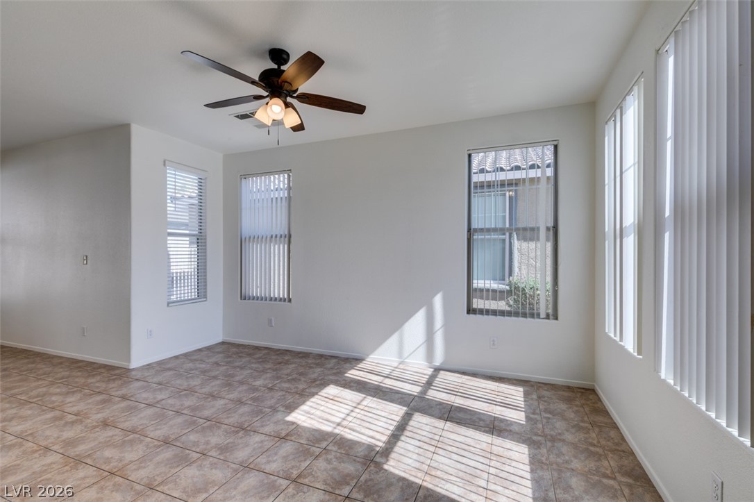 4957 Miners Ridge Drive Las Vegas, NV 89122 - Photo 4 of 39 This bright living space features abundant natural light, providing a welcoming and airy atmosphere.