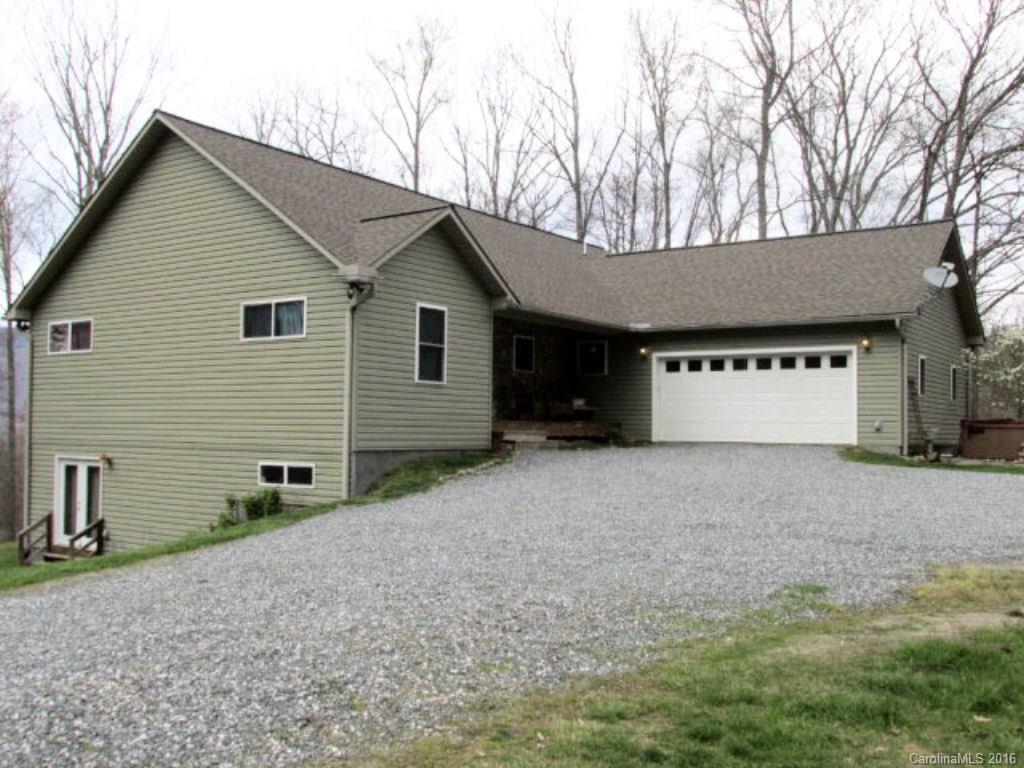 2574 Cabin Flats Road Sylva, NC 28779 - Photo 2 of 22 a view of a house with a yard and garage