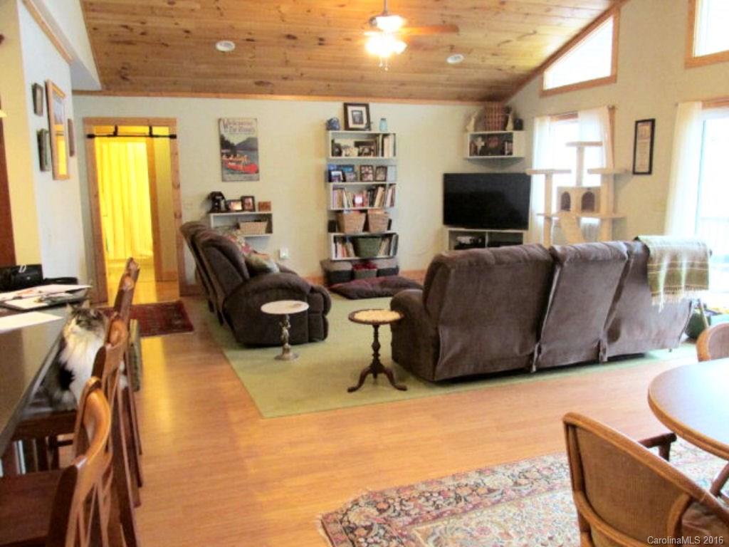 2574 Cabin Flats Road Sylva, NC 28779 - Photo 11 of 22 a living room with furniture a flat screen tv and a large window
